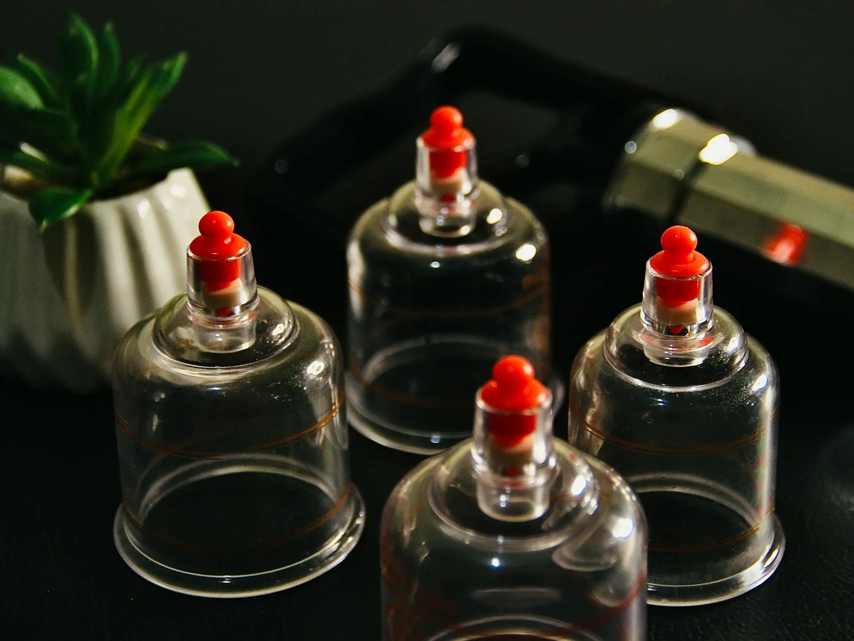 clear glass bottle with red lid